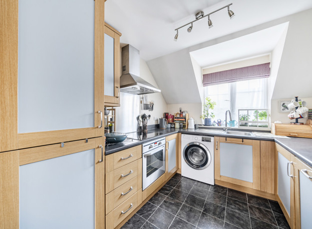 Kitchen with fitted units, appliances and washing machine.