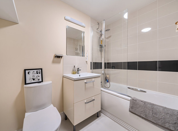 Bathroom with bath, shower, toilet and vanity unit.