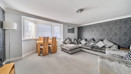 Living and dining area with corner sofa, table and chairs.