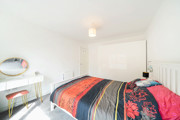 Double bedroom with bed, wardrobe and natural light.