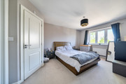 Spacious bedroom with double bed, built-in storage and window