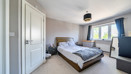 Spacious bedroom with double bed, built-in storage and window