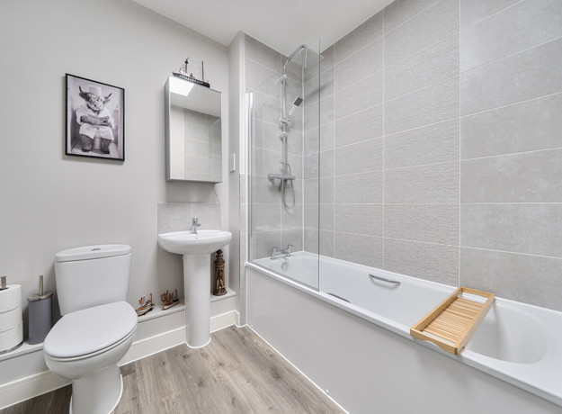 Bathroom with bathtub, shower, toilet, sink, and shelving.
