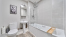 Bathroom with bathtub, shower, toilet, sink, and shelving.