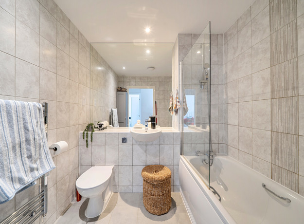 Bathroom with bath, shower screen, toilet and wash basin.