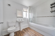 Bathroom with bath, shower, wash basin and toilet.