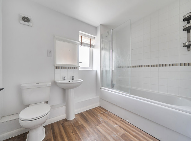 Bathroom with bath, shower, wash basin and toilet.
