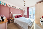 Bedroom with double bed, wardrobe, shelving, and window.