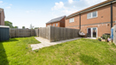 Rear garden with lawn, patio area and surrounding fencing.