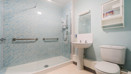 Bathroom with walk-in shower, toilet and sink.