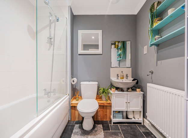 Bathroom with bathtub and shower, toilet, sink unit and tiled floor