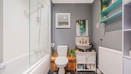 Bathroom with bathtub and shower, toilet, sink unit and tiled floor