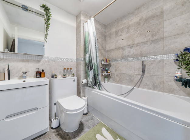 Bathroom with bath, shower, toilet, and vanity unit.