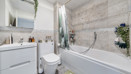 Bathroom with bath, shower, toilet, and vanity unit.