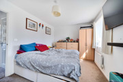 Bedroom with a double bed, wardrobe and wall-mounted television.