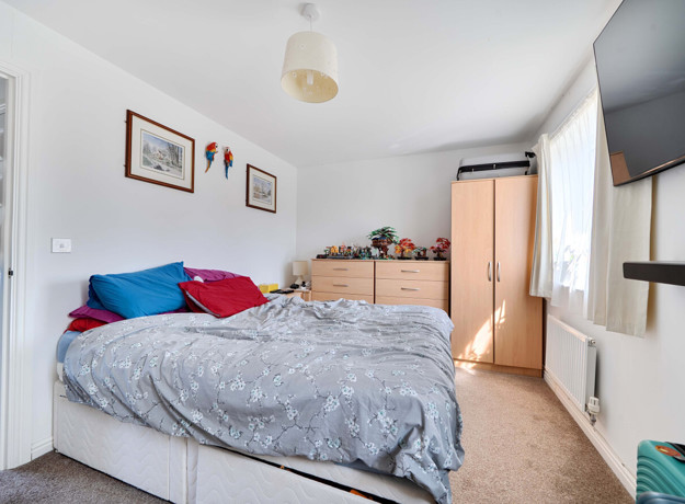 Bedroom with a double bed, wardrobe and wall-mounted television.