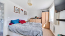 Bedroom with a double bed, wardrobe and wall-mounted television.