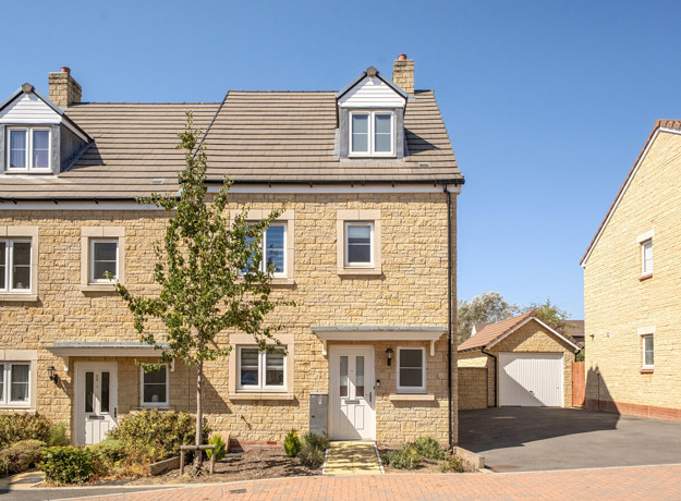Three-storey semi-detached house with driveway and front garden.