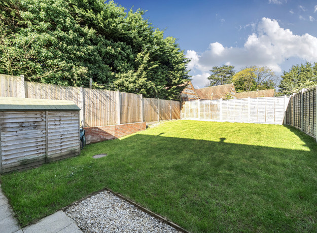 Rear garden with lawn and wooden fencing