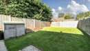 Rear garden with lawn and wooden fencing