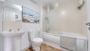 Bathroom with bath, shower, sink, toilet and tiled walls.