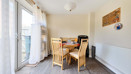 Dining area with a table, chairs and patio doors.
