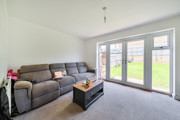 Living room with sofa, coffee table, and patio doors to the garden.