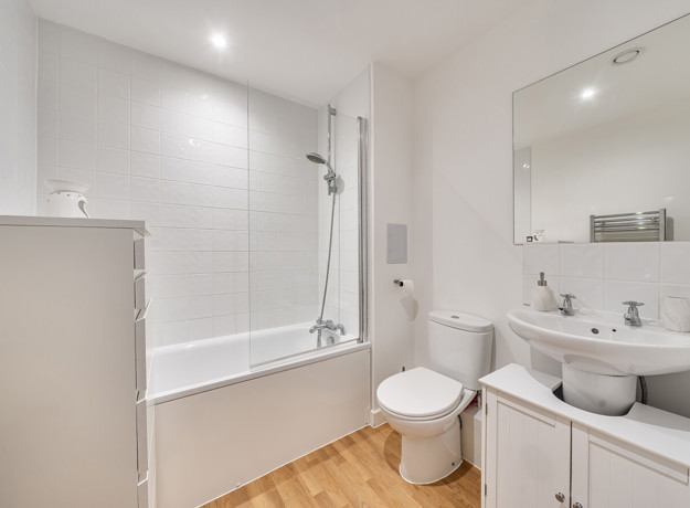 Bathroom with bath, shower, toilet and wash basin.
