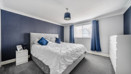 Bedroom with double bed, bedside tables, wardrobe and window.