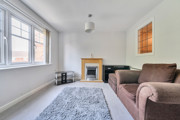 iving room with sofas, rug, fireplace and window.