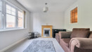 iving room with sofas, rug, fireplace and window.